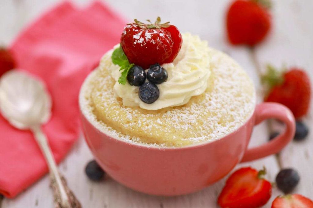 mug cake recipe with sponge cake filling in a pink cup